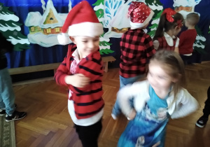 Dzieci bawią się przy muzyce z animatorką