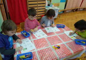 Dzieci pracują przy stolikach