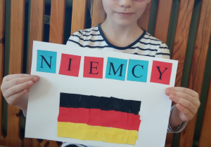 Dziewczynka prezentuje swą pracę.