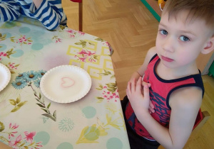 Dziecko układa obrazek z kolorowego makaronu