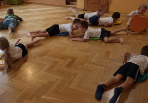 dzieci ćwiczą z kolorowymi krążkami