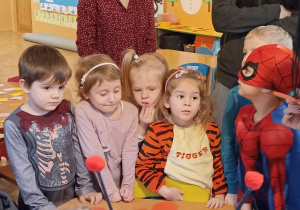 dzieci stoją przy stoliku