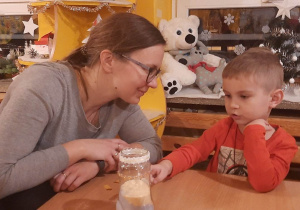 dzieci razem z rodzicami wykonują świeczniki