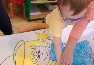 Dzieci wykonują pracę plastyczną "Aniołek"