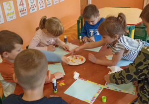 dzieci naklejają kolorowe listki