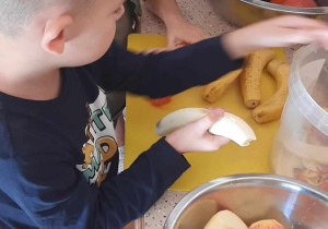 Dzieci obierają i kroją owoce