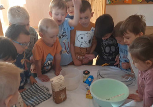 Dzieci mieszają składniki potrzebne na chleb
