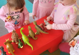Dzieci karmią dinozaura