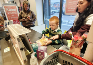 dzieci skanują na kasie produkty