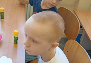 chłopiec siedzi w ławce