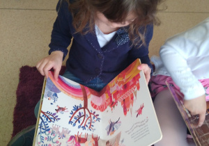 Dziewczynka ogląda książkę