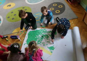 Dzieci wyklejają mapę