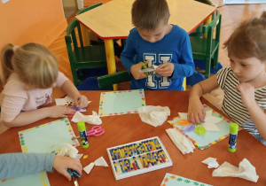 dzieci naklejają kolorowe listki