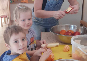Dzieci obierają i kroją owoce