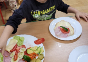 Dzieci jedzą przygotowane przez siebie śniadanie