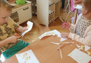 dzieci wycinają przy stole