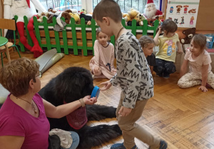 dzieci głaszczą psa