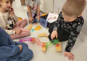 dzieci siedzą na macie