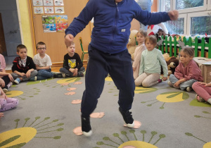 dzieci chodzą po stopkach misia