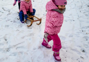 dzieci jadą na sankach