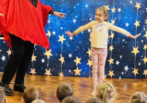 dziewczynka stoi z iluzjonistą