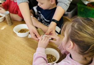 Dzieci przygotowują jedzenie dla ptaków