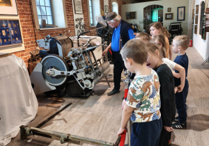 dzieci stoją przy maszynie