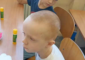 chłopiec siedzi w ławce