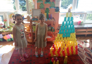 Dziewczynki zbudowały wieżę z kubków.